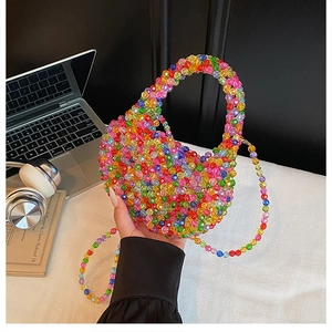 Detail of colorful handmade beaded bag with removable crossbody strap and woven texture