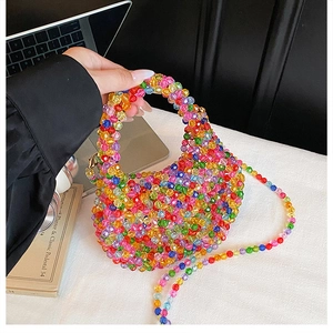 Macro shot of colorful beaded tote bag showing rainbow acrylic beads and crossbody strap