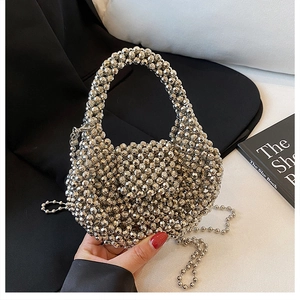 Close-up of silver beaded handbag with metallic finish pearls and detachable shoulder chain