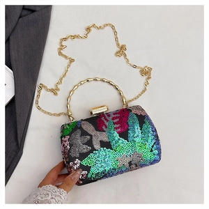 Detailed close-up of a floral sequin embroidery dinner bag with golden bamboo handle