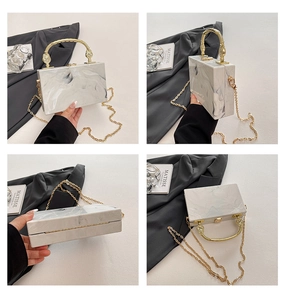 Detail shots of marble pattern acrylic evening clutch with vintage gold handle and chain