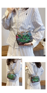 Detailed views of sequined evening bag with floral embroidery and golden chain strap
