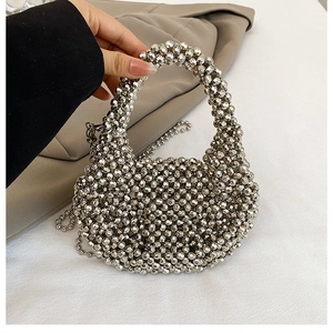 Detail of silver beaded handbag with round handle and detachable shoulder strap