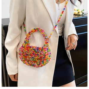 Detail of a colorful beaded crossbody bag featuring vibrant beads and a detachable strap