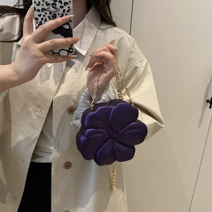 Elegant purple flower-shaped acrylic evening bag with a gold metal chain strap