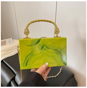 Detail of lime green acrylic marble clutch with gold metal handle and chain strap