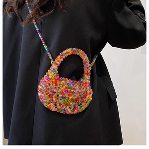 Detailed close-up of a colorful handmade beaded handbag with vibrant rainbow beads