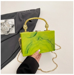 Detail of green marble acrylic evening bag with gold floral handle and chain
