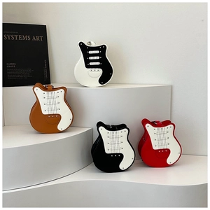 Detail view of four creative guitar-shaped shoulder bags with studs and wide straps