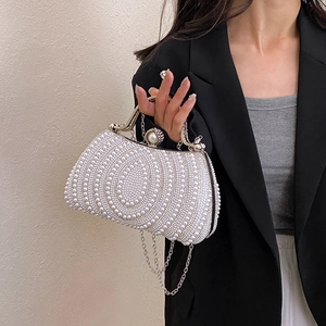 Elegant pearl evening clutch with gold metal handle and chain strap for luxury parties