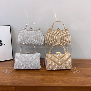 Elegant pearl evening clutch bag with metal handle and detachable chain in gold and silver