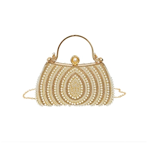 Elegant gold evening clutch bag with intricate pearl beading and a metal chain strap