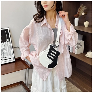 Detail view of electric guitar shaped crossbody bag with stylish wide shoulder strap