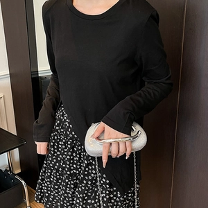 Elegant silver rhinestone clutch bag with metal handle paired with a chic floral skirt