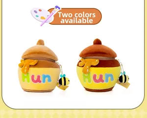 Detail of honey pot plush bag in two colors with bee pendant and Hun embroidery