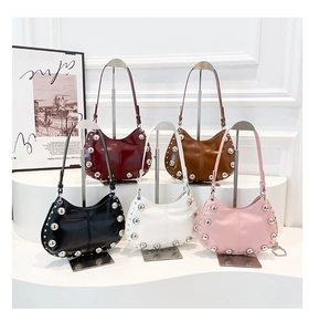 Hobo bags in five colors with silver studs on minimalist white pedestals