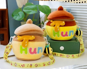 Detail of honey pot plush crossbody bag with colorful Hun embroidery and bee charm