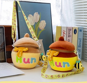 Detail of honey pot plush bags in light and dark brown with cute bee charms