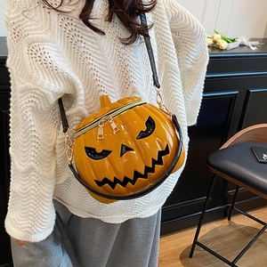 Chic Halloween pumpkin crossbody bag in bright orange glossy leather with jack-o-lantern face