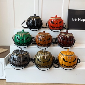 Halloween pumpkin cross-body bags in various colors on white geometric stands