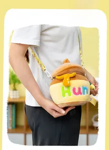 Detail shot of plush honey pot crossbody bag with embroidered Hun and 3D honey drops