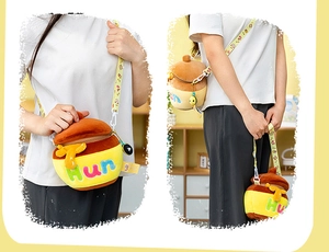 Detail view of honey pot plush bag featuring yellow soft fur and embroidered Hun text