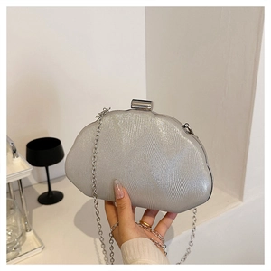Detail of silver shell evening bag with pearlescent wave texture and metal chain