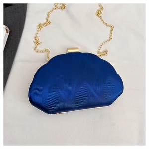 Deep blue shell evening clutch with gold metal clasp and wavy textured finish