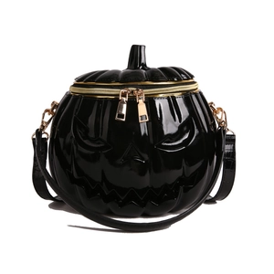 Glossy black pumpkin shaped crossbody bag with gold hardware for Halloween costume