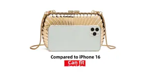 Golden metallic box clutch showing size comparison with a smartphone and shell texture