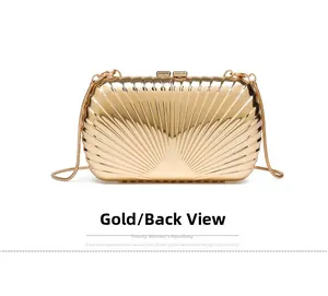 Detail view of the back side of a gold shell-shaped metal evening clutch with snake chain