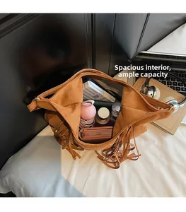 Detailed interior of brown suede hobo bag showing magnetic closure and large capacity
