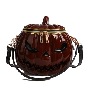 Halloween pumpkin crossbody bag in burgundy patent leather with carved face design