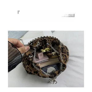 Detail of leopard print bucket bag interior showing large capacity for essentials