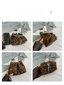 Detail view of leopard print bucket bag with rhinestone handle and size comparison