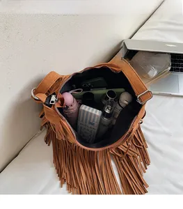 Detailed internal view of large brown suede tassel shoulder bag showing daily storage capacity