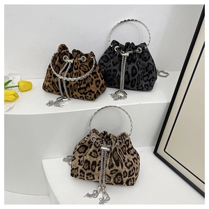 Detailed view of leopard print bucket bags with metal ring handles and chain tassels