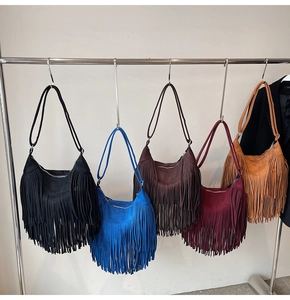 Detail shot of boho crescent shoulder bags with long tassels in five rich colors