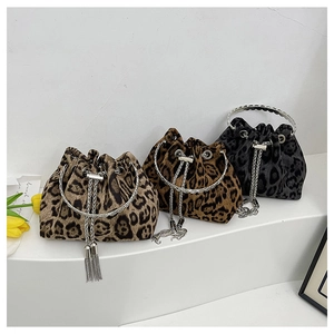 Detailed view of leopard print bucket bags with metal ring handles and tassel chain drawstrings