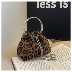 Close-up of leopard print bucket bag with silver metal ring handle and tassel drawstring