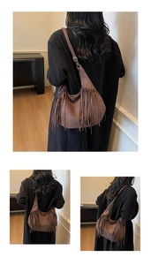 Detail of brown suede hobo bag with long fringe tassels and adjustable shoulder strap