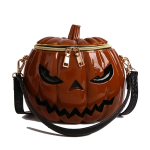 Orange gloss patent leather pumpkin crossbody bag with black Jack-o'-lantern face