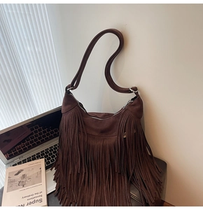 Macro detail of dark brown suede fringe hobo bag with high quality metal zipper and tassel