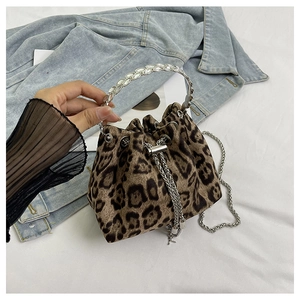 Detail of leopard print bucket bag with rhinestone ring handle and silver drawstring chain