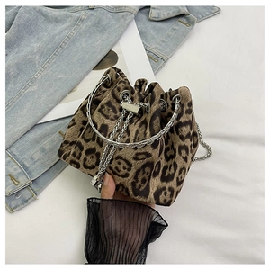 Close-up of leopard print bucket bag featuring silver chain drawstring and fuzzy texture
