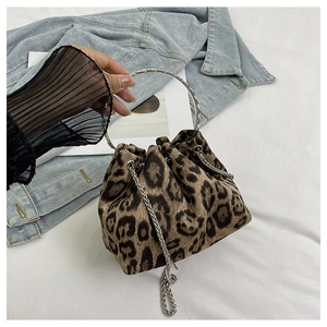 Close-up of leopard print bucket bag with silver metal ring handle and chain strap