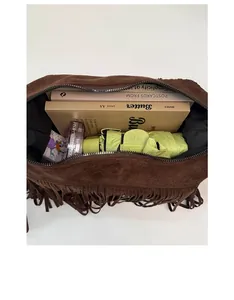 Top view of spacious interior of brown suede tassel bag showing daily storage capacity