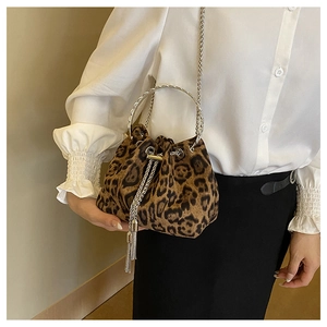 Detail of leopard print bucket bag with metal ring handle and drawstring tassels