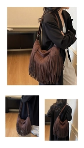 Detail view of a dark brown suede fringe bag with bohemian tassel design and wide strap