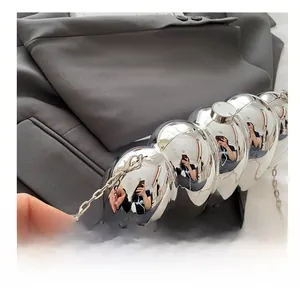 Detail of silver mirror acrylic bag with sphere structure and metal chain hook
